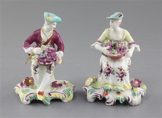 A near pair of Derby seated figures of fruit sellers, c.1759-60, h. 12.5cm, small losses and slight restoration